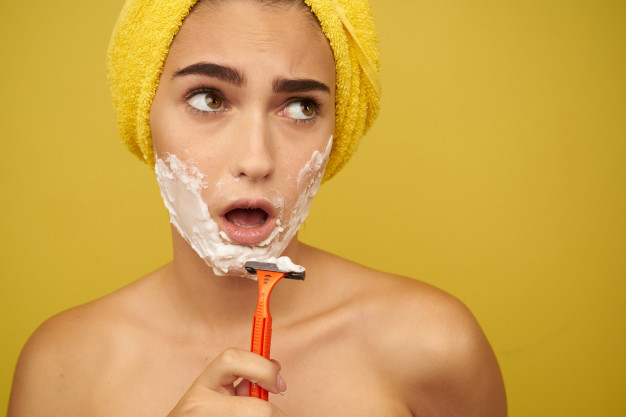 woman-shaves-her-face-with-razor-hair-removal-facial-hair-removal_163305-8952