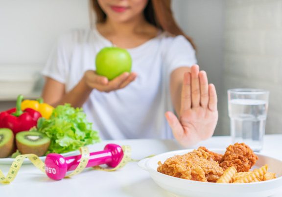 close-up-young-asian-woman-using-hand-push-out-her-favourite-fried-chicken-french-fries-choose-green-apple-fruit-vegetables-good-health-woman-dieting-concept-close-up_164138-700