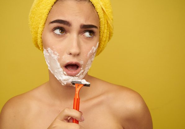 woman-shaves-her-face-with-razor-hair-removal-facial-hair-removal_163305-8952